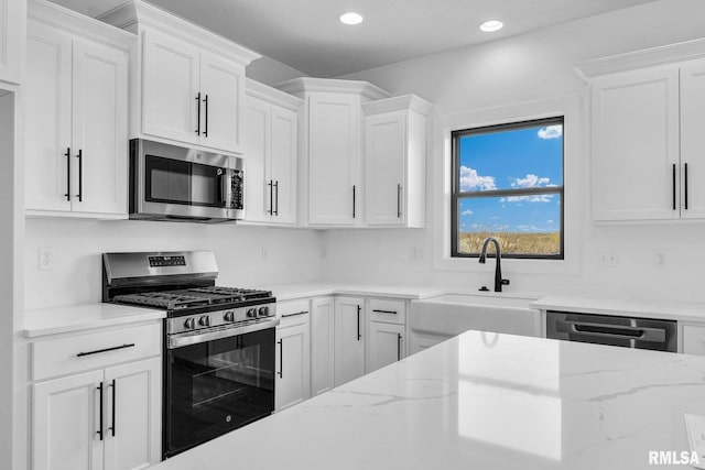 kitchen featuring white cabinetry, appliances with stainless steel finishes, and sink