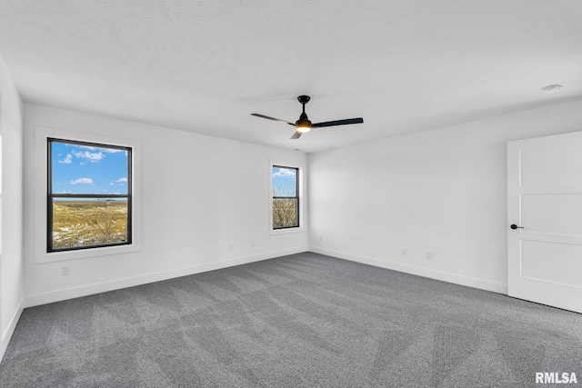 spare room with carpet floors and ceiling fan