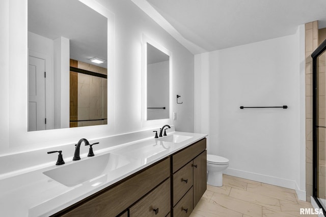 bathroom featuring vanity, a shower with door, and toilet