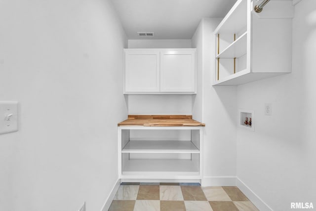 washroom featuring cabinets and washer hookup