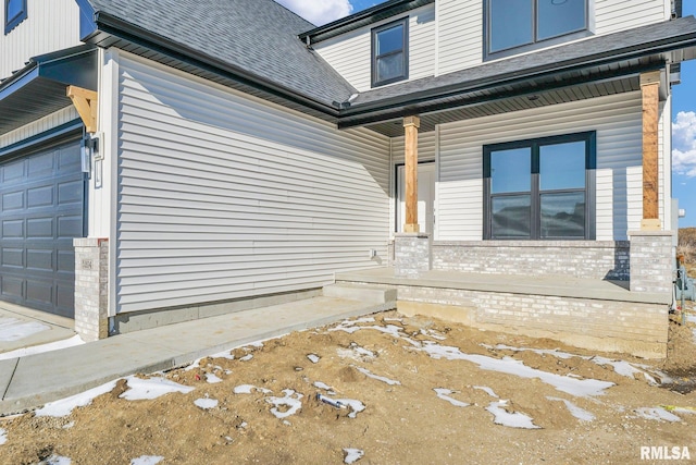 property entrance with a garage and covered porch