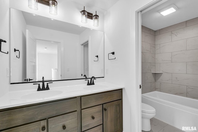 full bathroom with vanity, tiled shower / bath, and toilet