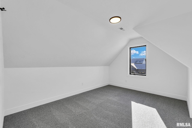 bonus room with lofted ceiling and carpet