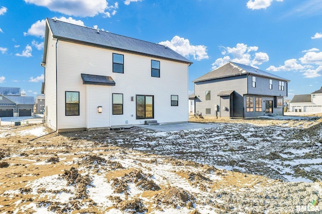 view of snow covered rear of property