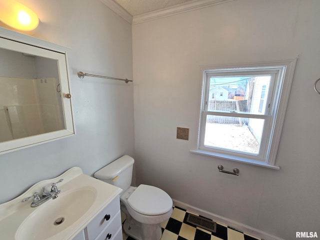 bathroom with toilet, vanity, a shower, and ornamental molding