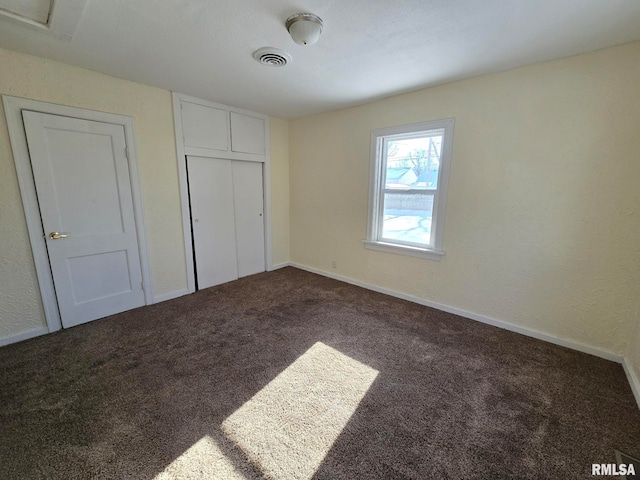 unfurnished bedroom with carpet floors and a closet