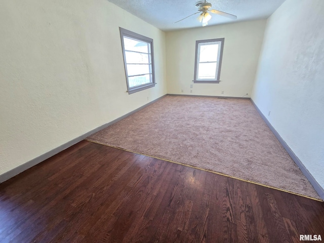 spare room with ceiling fan, a textured ceiling, and hardwood / wood-style flooring