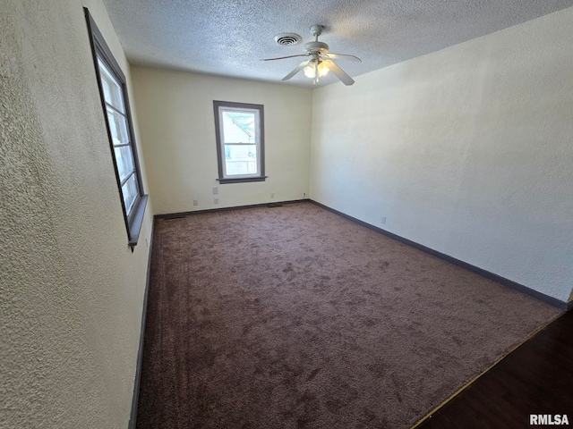 empty room featuring ceiling fan and a textured ceiling