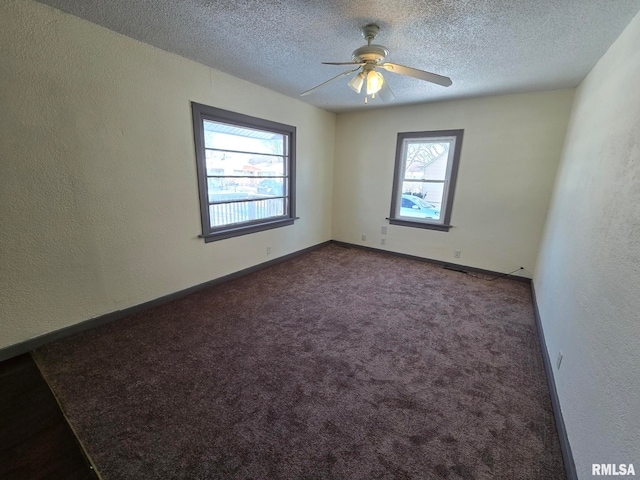 carpeted spare room with ceiling fan and a textured ceiling