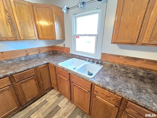 kitchen with light wood-type flooring and sink