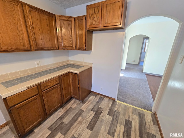 kitchen featuring light hardwood / wood-style floors and tile counters