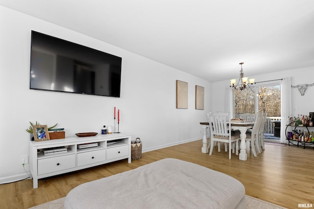 dining room featuring a chandelier and light hardwood / wood-style flooring