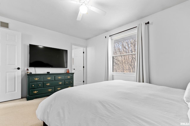 bedroom featuring ceiling fan and light carpet