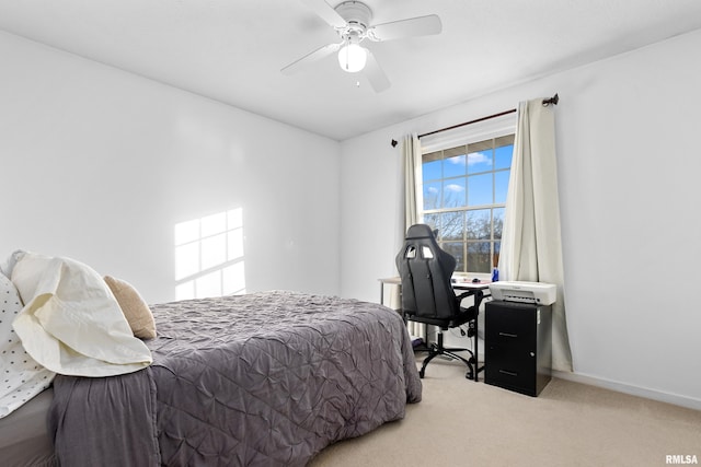 bedroom with ceiling fan and light carpet