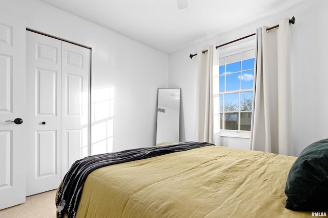 bedroom featuring ceiling fan, carpet, and a closet