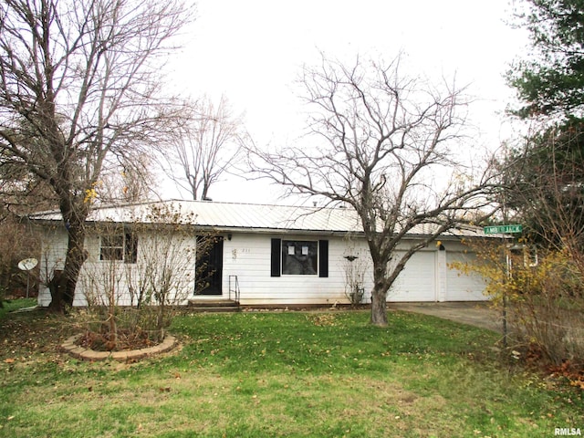 ranch-style home featuring a garage and a front lawn