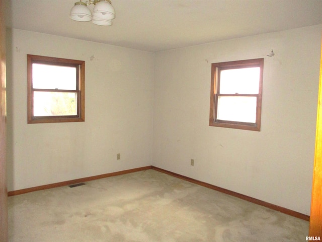 spare room with light colored carpet