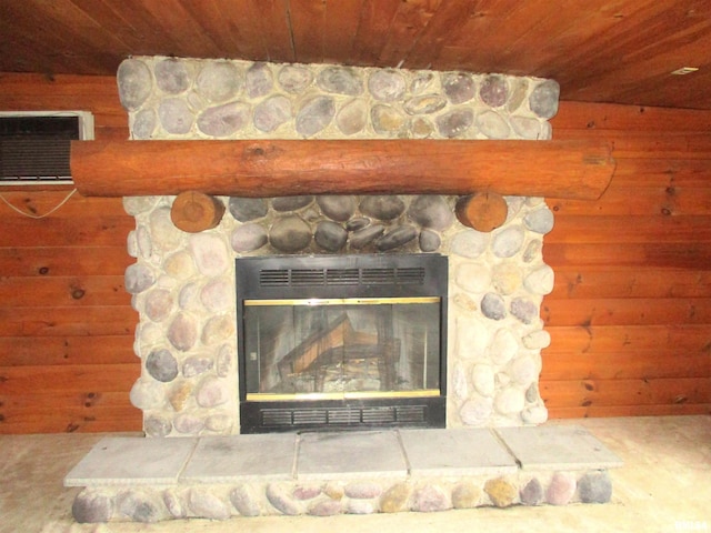 details featuring a wall mounted AC and a stone fireplace