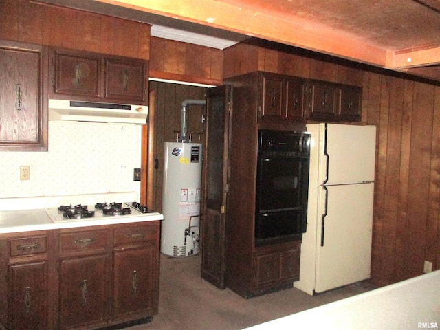 kitchen with water heater, wood walls, and white appliances