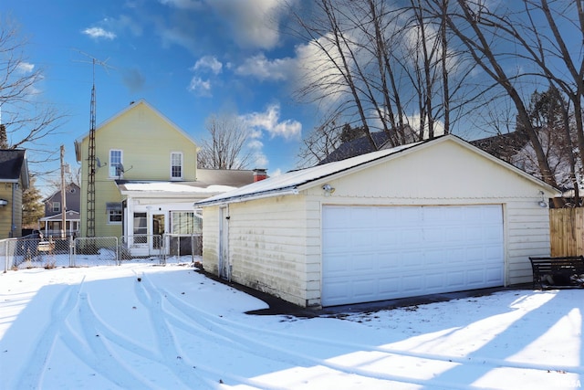 view of front facade featuring a garage and an outbuilding