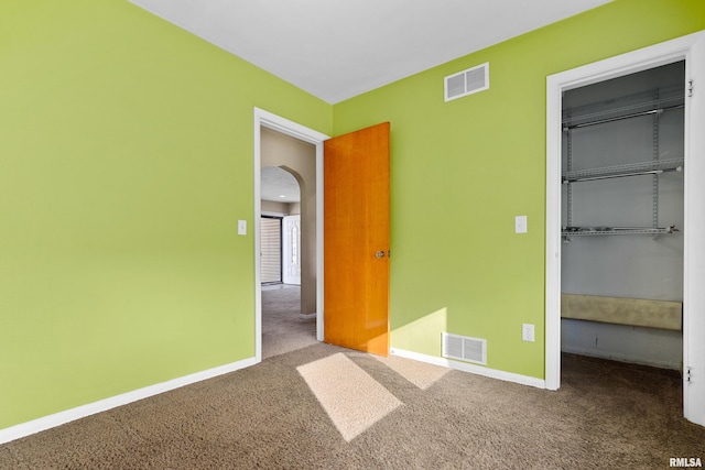 unfurnished bedroom featuring carpet and a closet