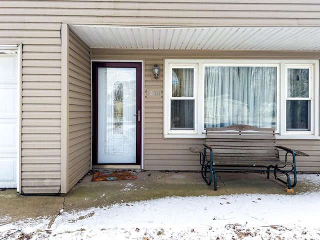 view of snow covered property entrance