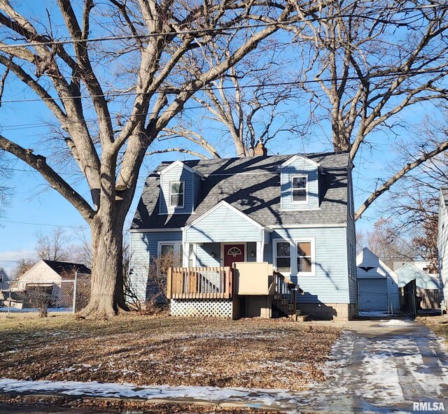 view of front of property with driveway, a chimney, and a shingled roof