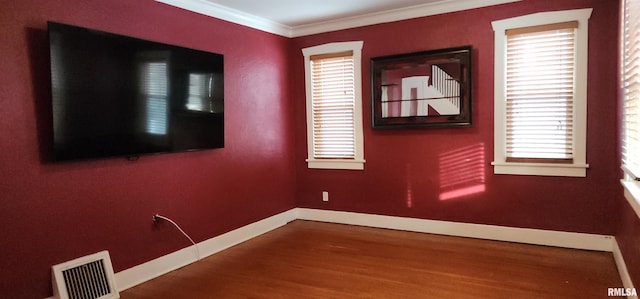 unfurnished room with wood-type flooring and ornamental molding