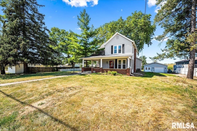 view of front of home featuring covered porch, a front lawn, and a shed