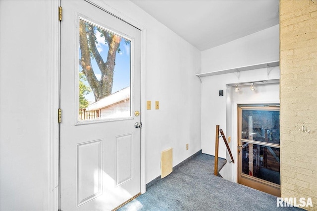 doorway with dark colored carpet