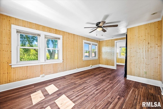 unfurnished room with ceiling fan, dark wood-type flooring, and ornamental molding