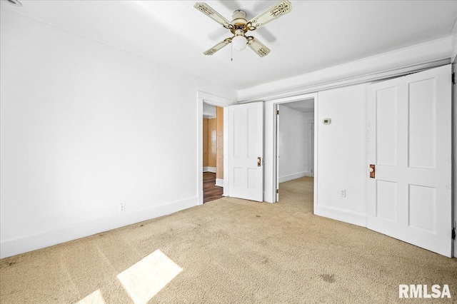 unfurnished bedroom featuring ceiling fan and carpet flooring