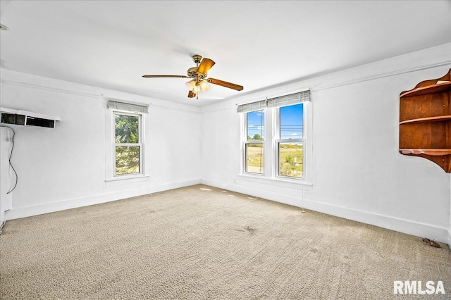 spare room with ceiling fan, ornamental molding, and carpet floors