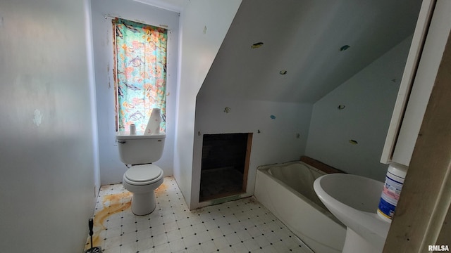 bathroom with toilet, vaulted ceiling, and a bathing tub