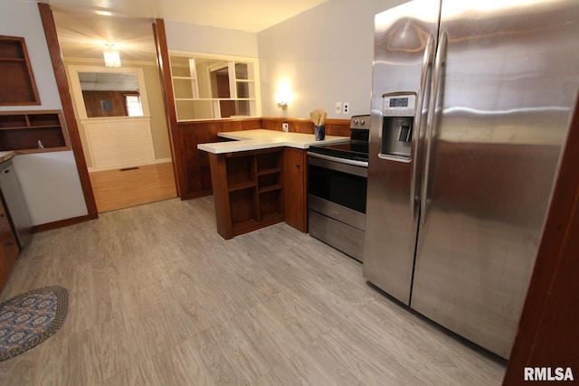 kitchen featuring kitchen peninsula, stainless steel appliances, and light wood-type flooring