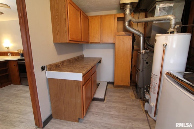 kitchen featuring gas water heater and light wood-type flooring