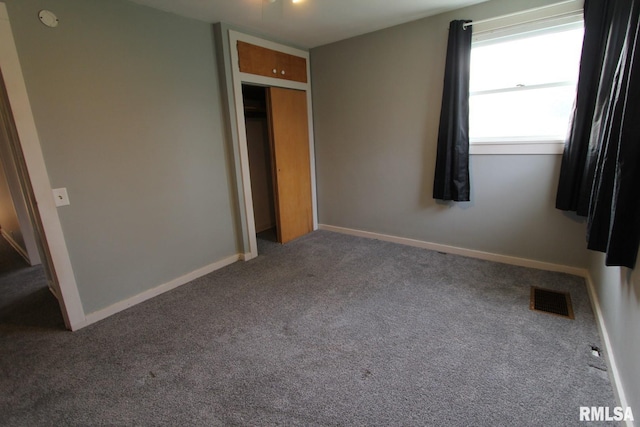 unfurnished bedroom with carpet and a closet