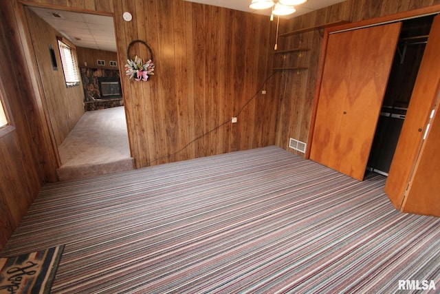 interior space with wood walls and a fireplace