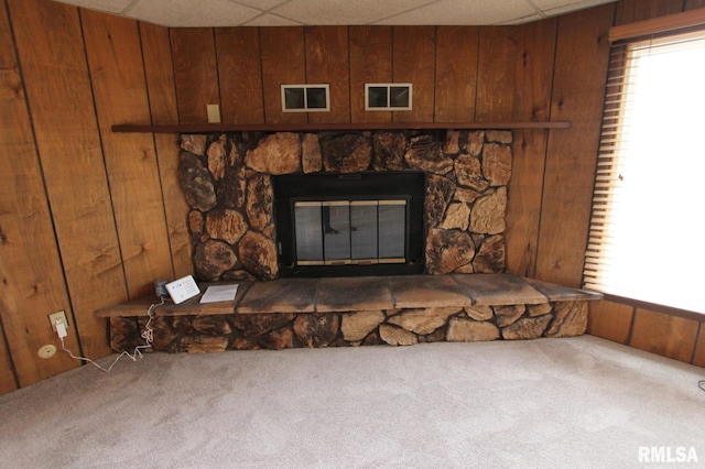 room details with wooden walls, carpet flooring, and a drop ceiling