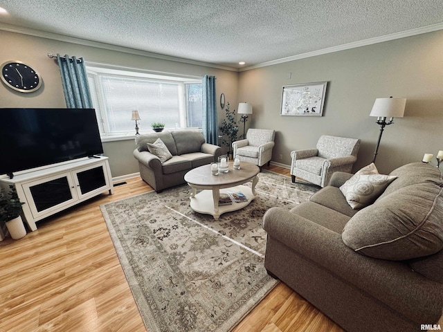 living room featuring wood-type flooring, a textured ceiling, and crown molding