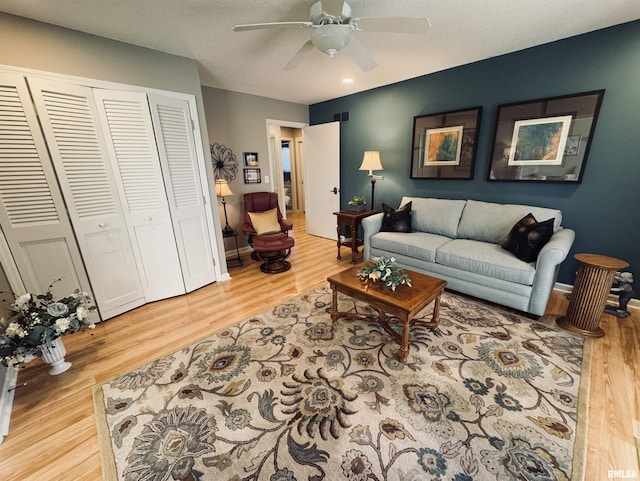 living room with ceiling fan and hardwood / wood-style floors