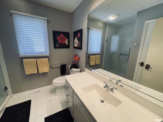 bathroom with vanity, toilet, tile patterned flooring, and an enclosed shower