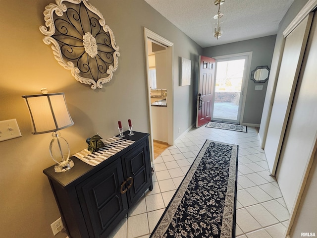 entryway featuring a textured ceiling and light tile patterned flooring