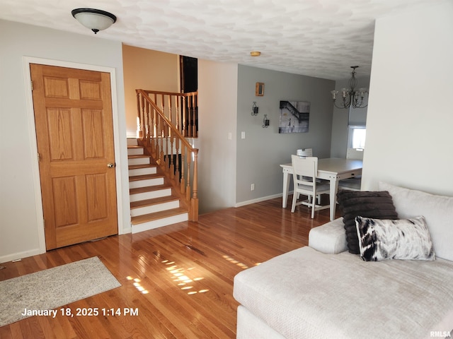 living room featuring an inviting chandelier and wood-type flooring