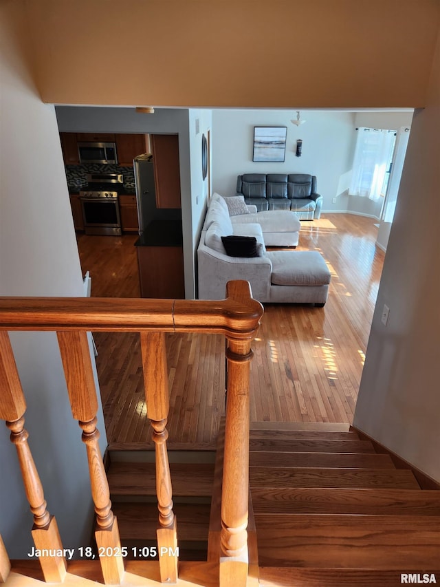 stairs featuring hardwood / wood-style flooring