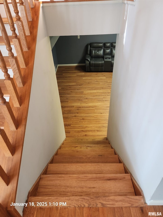 stairs with hardwood / wood-style flooring