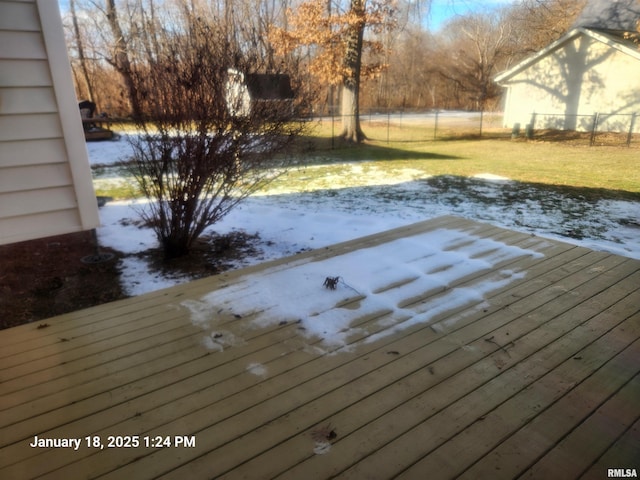 snow covered deck featuring a yard