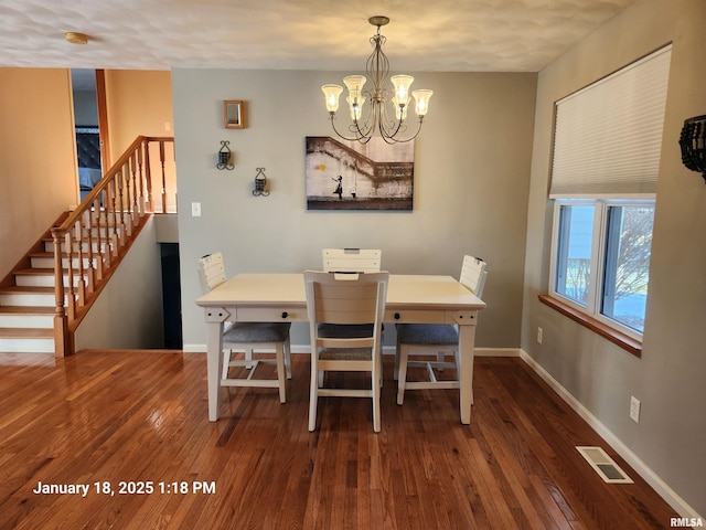 dining space featuring an inviting chandelier and dark hardwood / wood-style floors