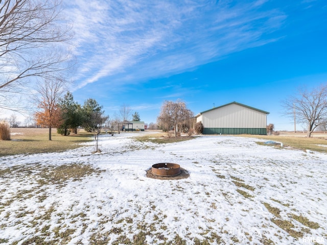 snowy yard featuring a fire pit