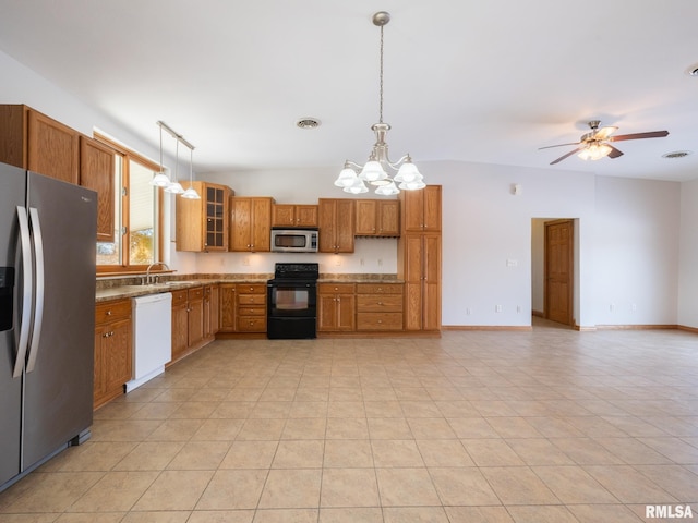 kitchen featuring vaulted ceiling, pendant lighting, stainless steel appliances, light tile patterned floors, and ceiling fan with notable chandelier